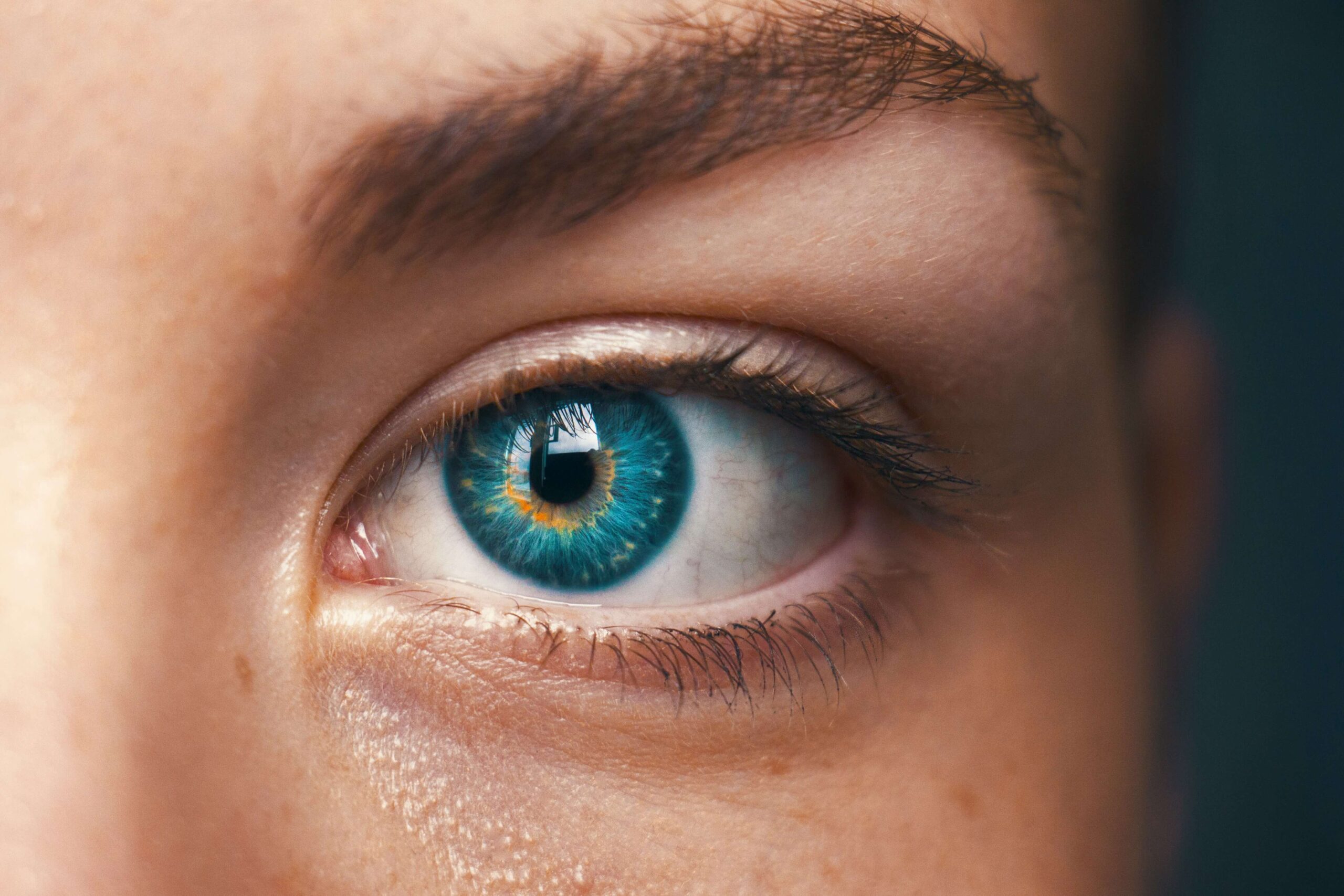 A close up of a woman's blue eye